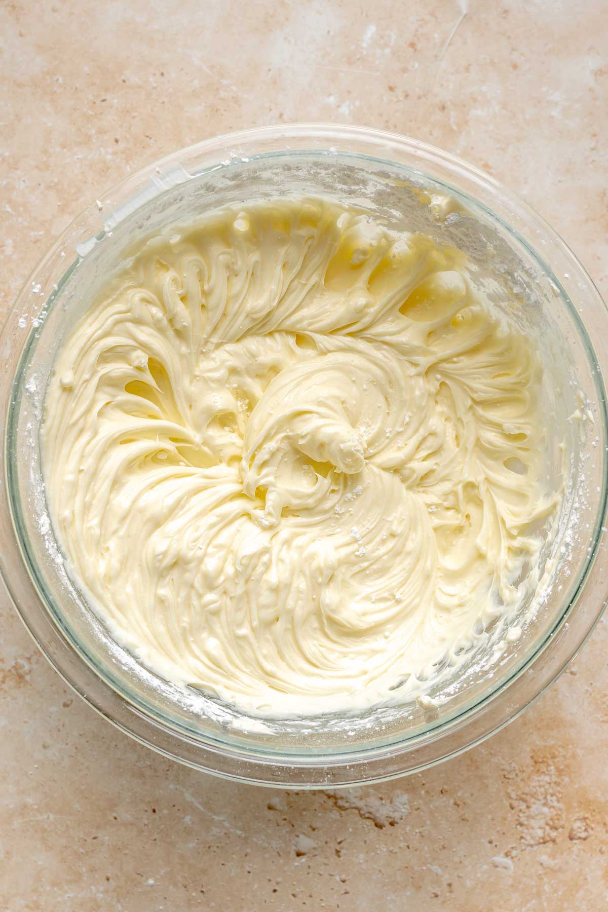 Creamed cheesecake batter in a mixing bowl.