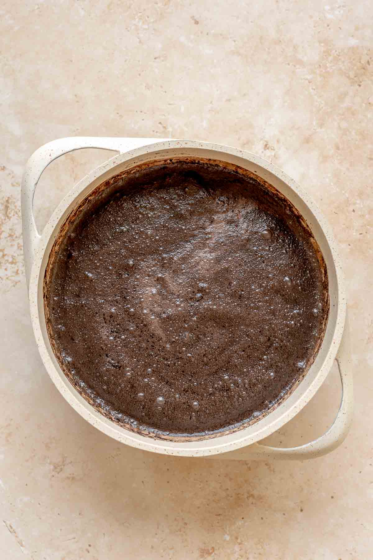 Cocoa powder and liquid mixed together in a saucepan.
