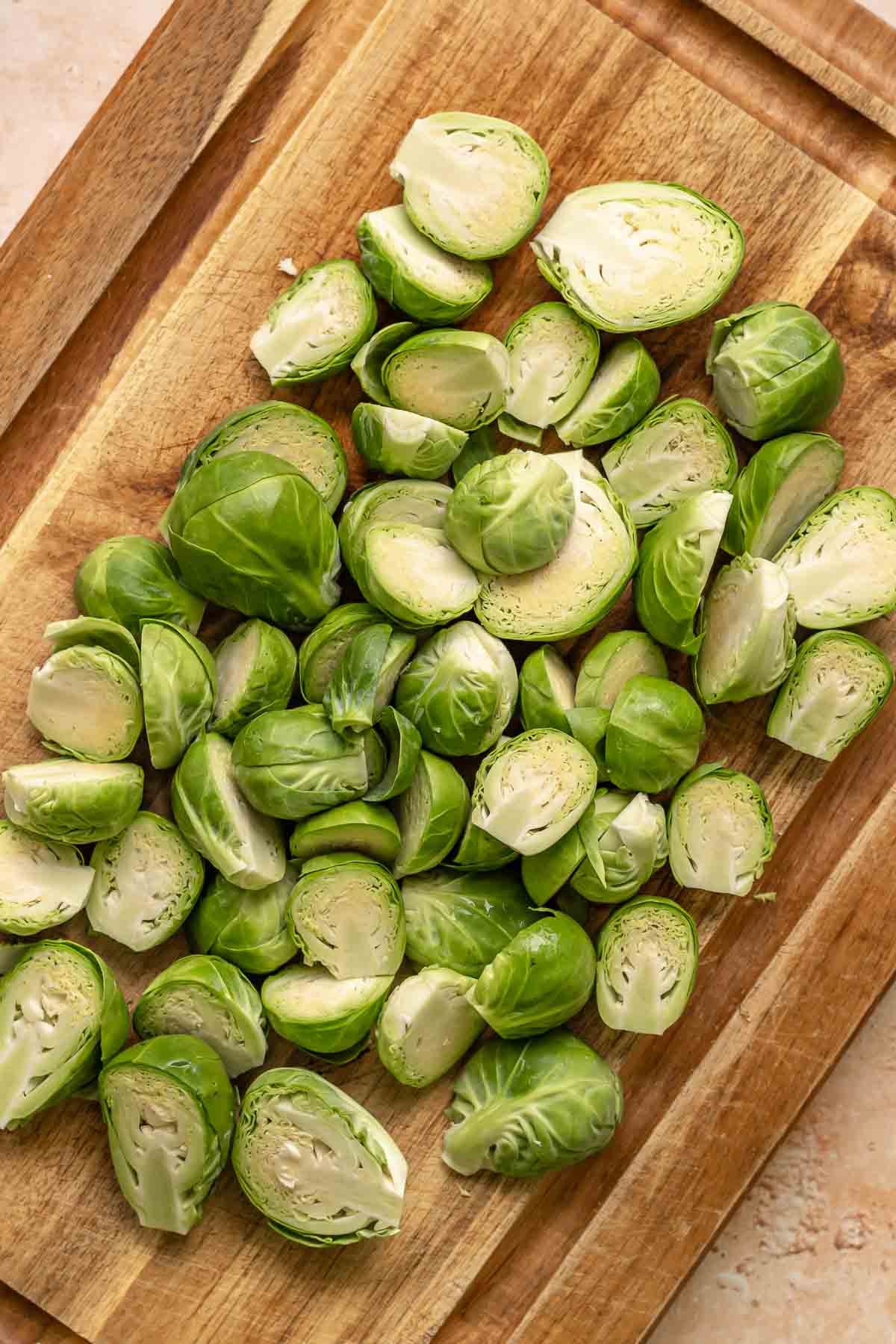Cut brussels sprouts on a cutting board.