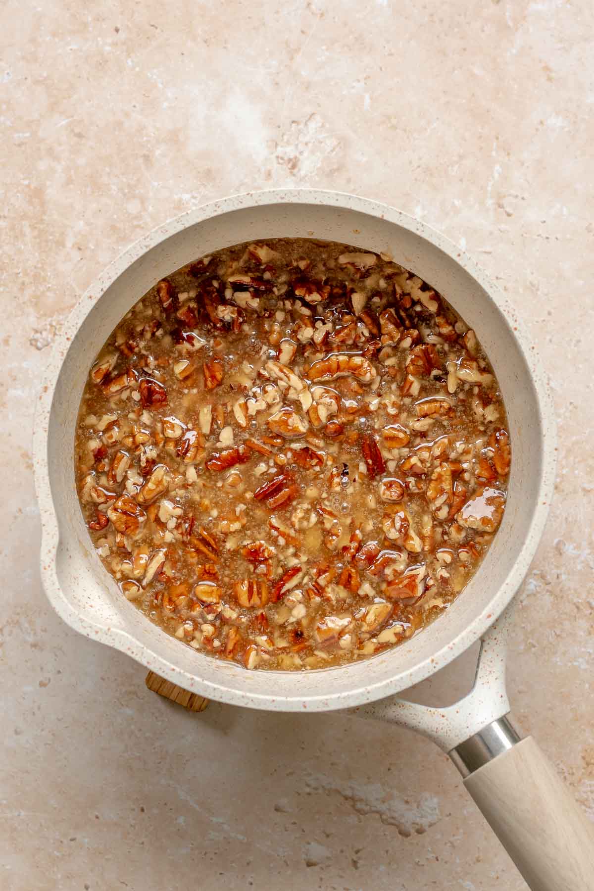 Pecans and syrup in a saucepan.