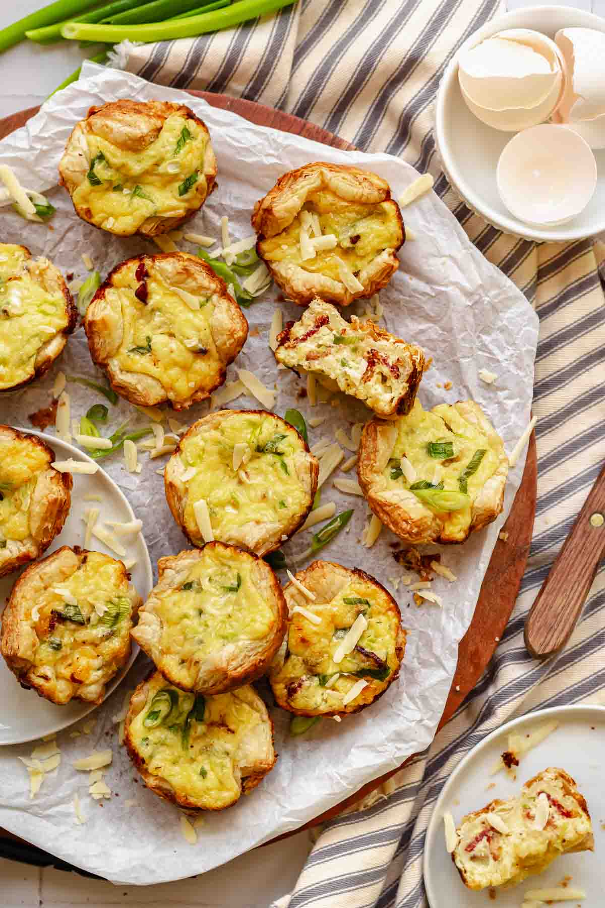 Mini puff pastry quiches on a platter.