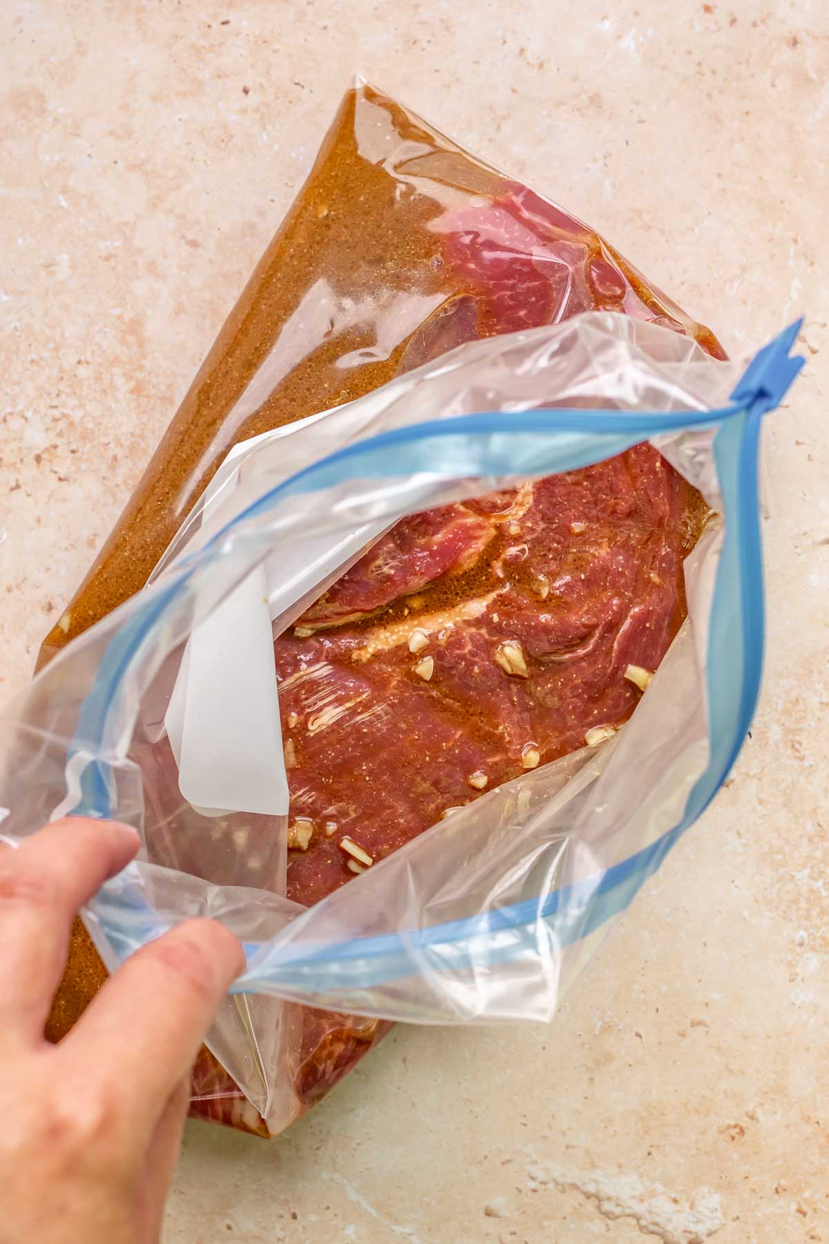 Steak and marinade in a zip top bag.