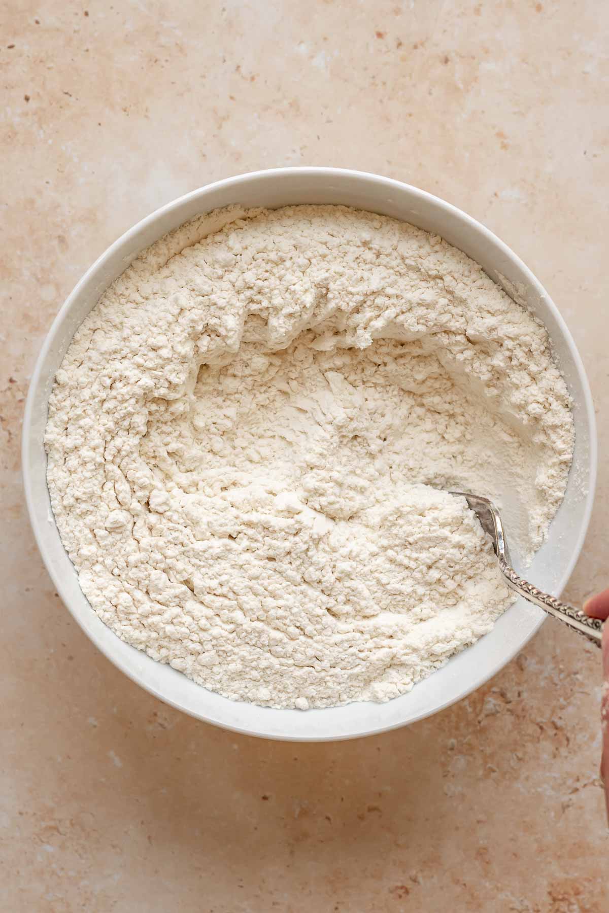 Flour and baking powder mixed in a bowl.