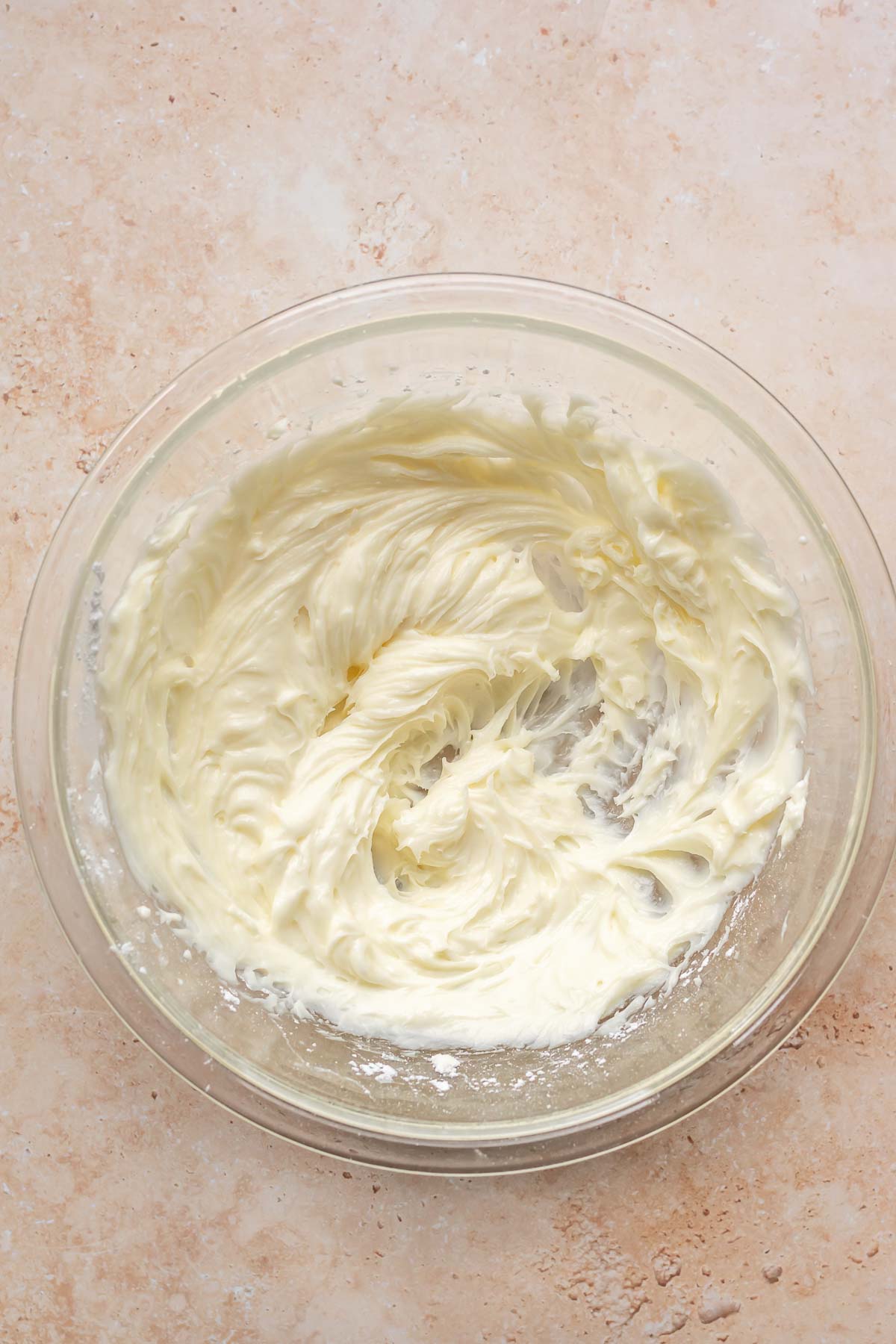 Cream cheese and powdered sugar creamed together in a bowl.