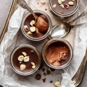 Nutella mousse cups on platter with spoons,.