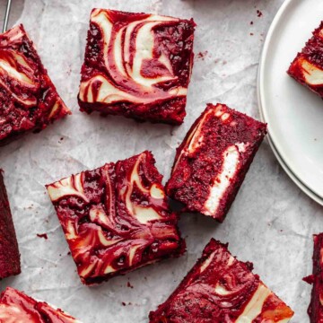 Pieces of red velvet brownies on parchment paper.