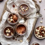 Nutella mousse cups on platter with spoons,.