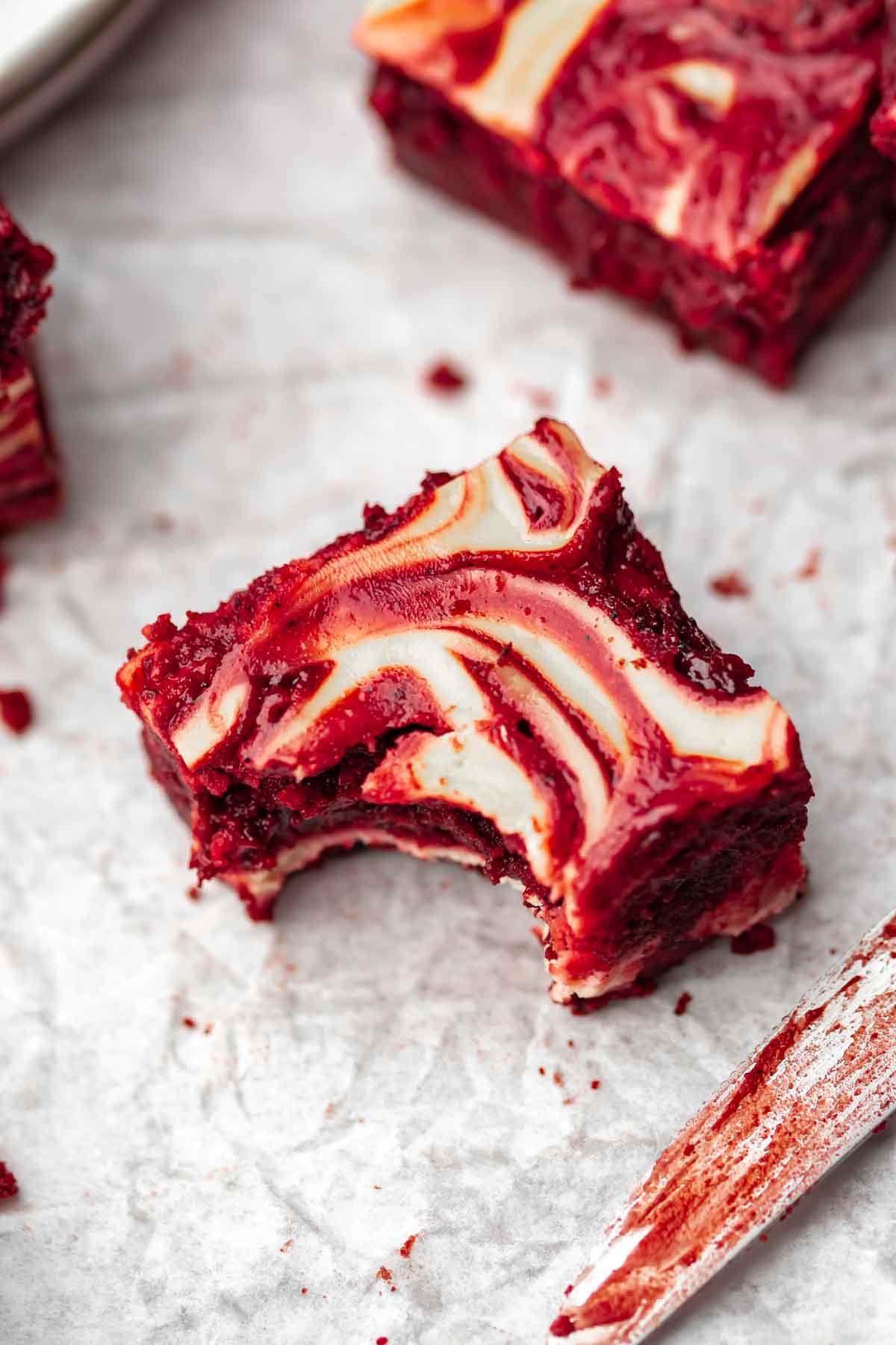 A red velvet brownie with a bite taken out of the corner.