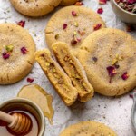 Baklava cookie cut open next to other cookies.
