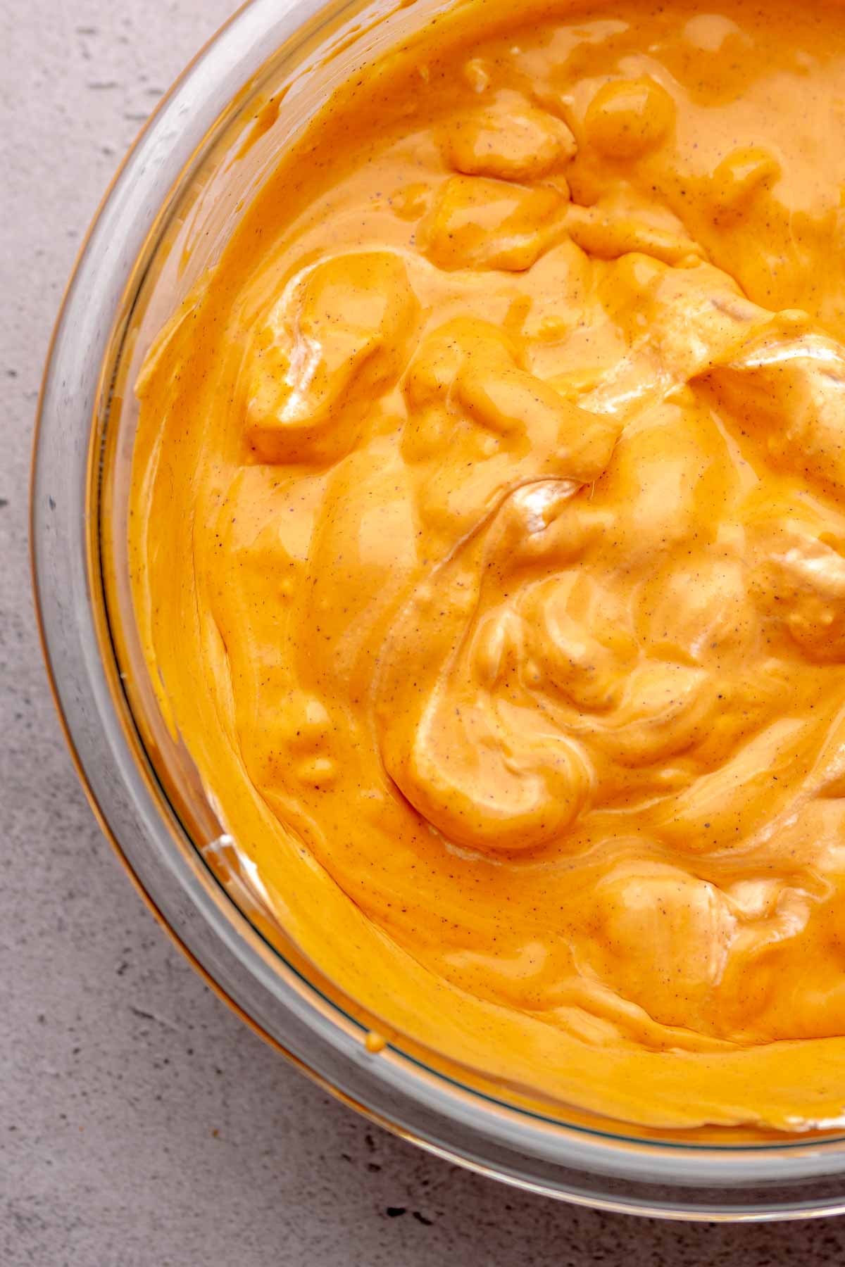 Whipped cream and Thai tea base in a bowl.