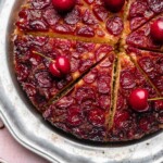 Sliced cherry upside down cake on a platter.