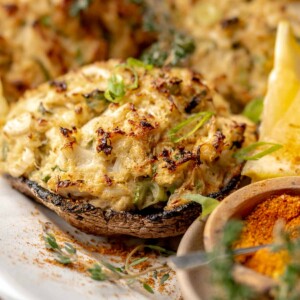 Crab stuffed portobello mushroom on a platter.