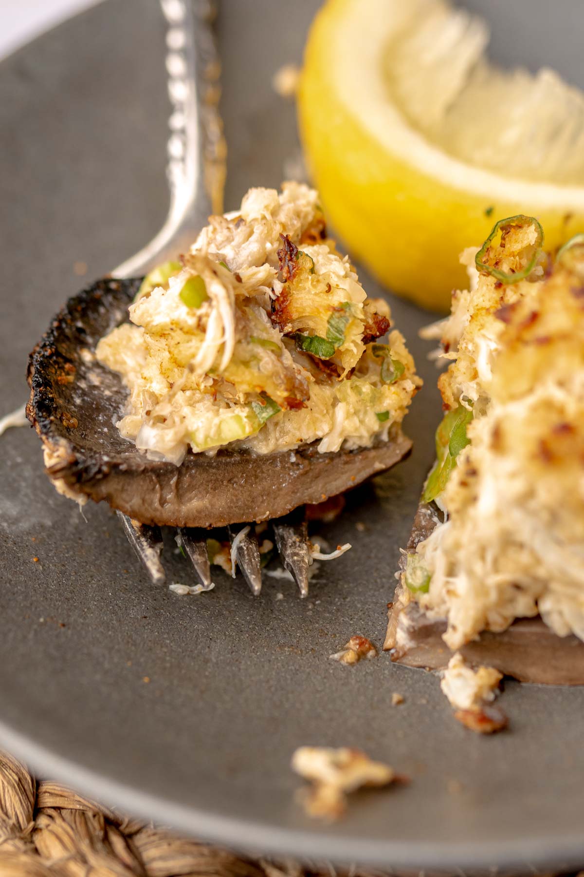 A piece of crab stuffed portobello mushroom on a fork.