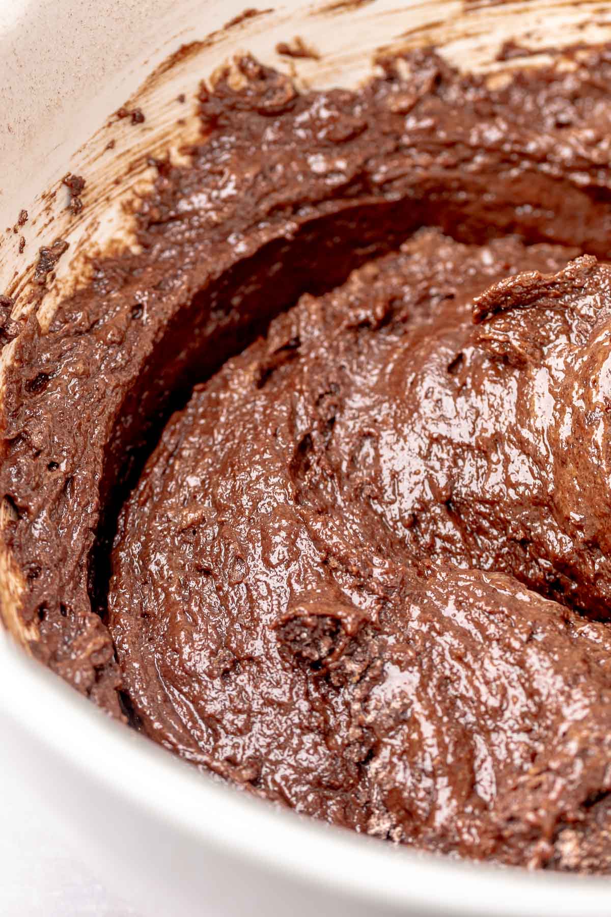 Thick chocolate cupcake batter in a bowl.