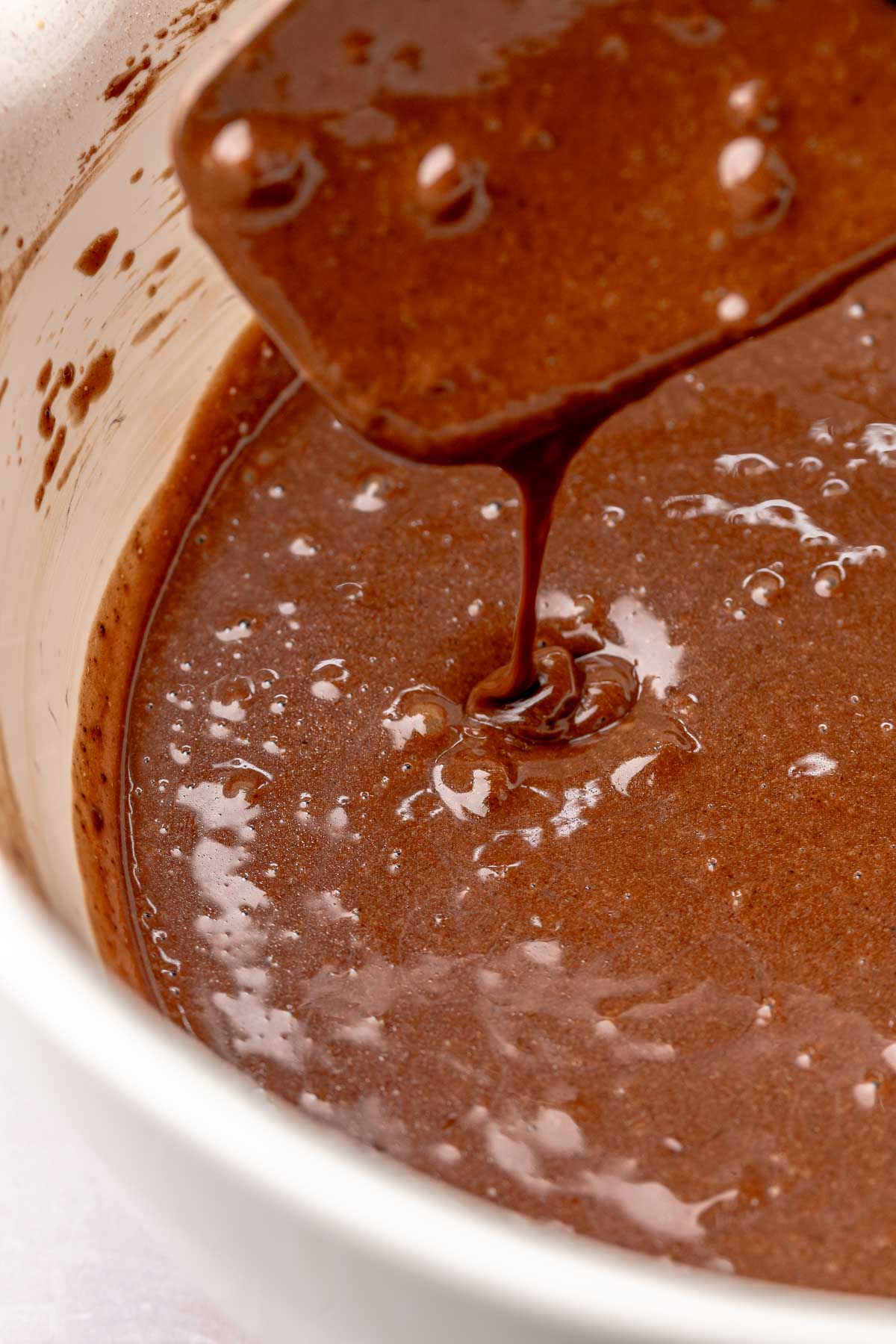 Thin chocolate cupcake batter in a bowl.