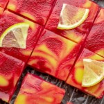 Sliced cranberry lemon bars on a wire rack.