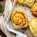 A savory breakfast roll in a casserole dish, sitting on a spatula.