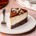 A slice of white chocolate mousse cake on a plate.