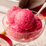 Scoops of rhubarb sorbet in an ice cream bowl.