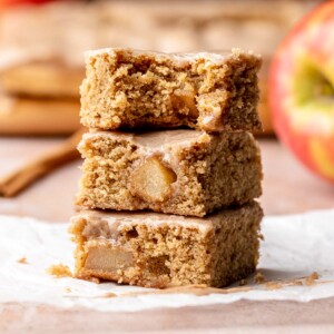 A stack of cinnamon apple blondies. The top bar has a bite removed.