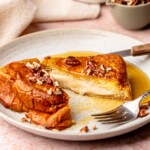 Pumpkin stuffed french toast sliced open on a plate.