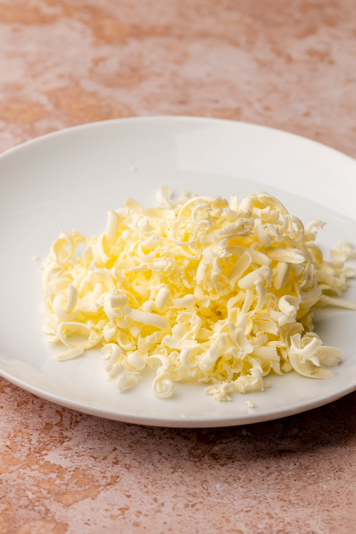Grated butter on a plate.