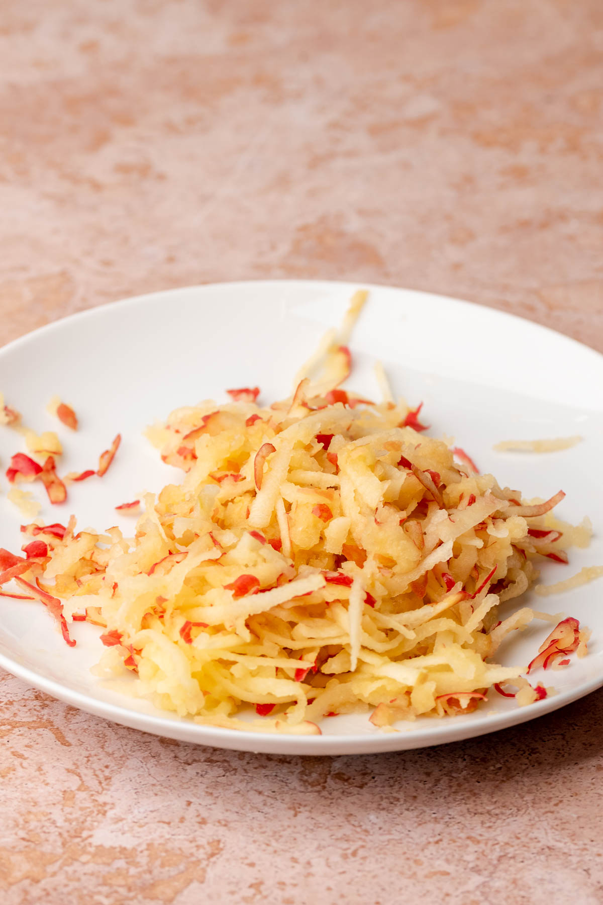Grated apples on a plate.