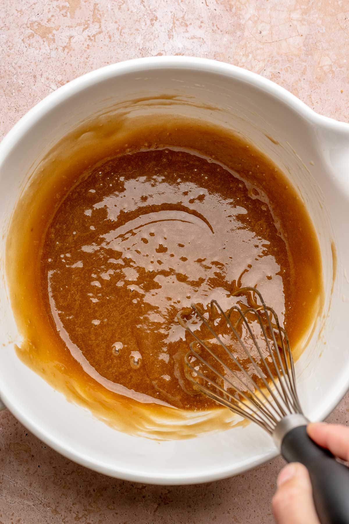 A whisk mixes blondie batter.