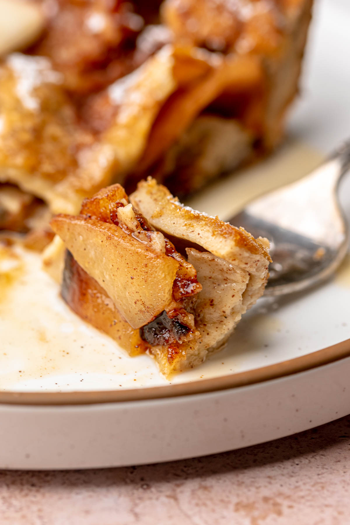 A piece of cinnamon apple dutch baby on a fork.