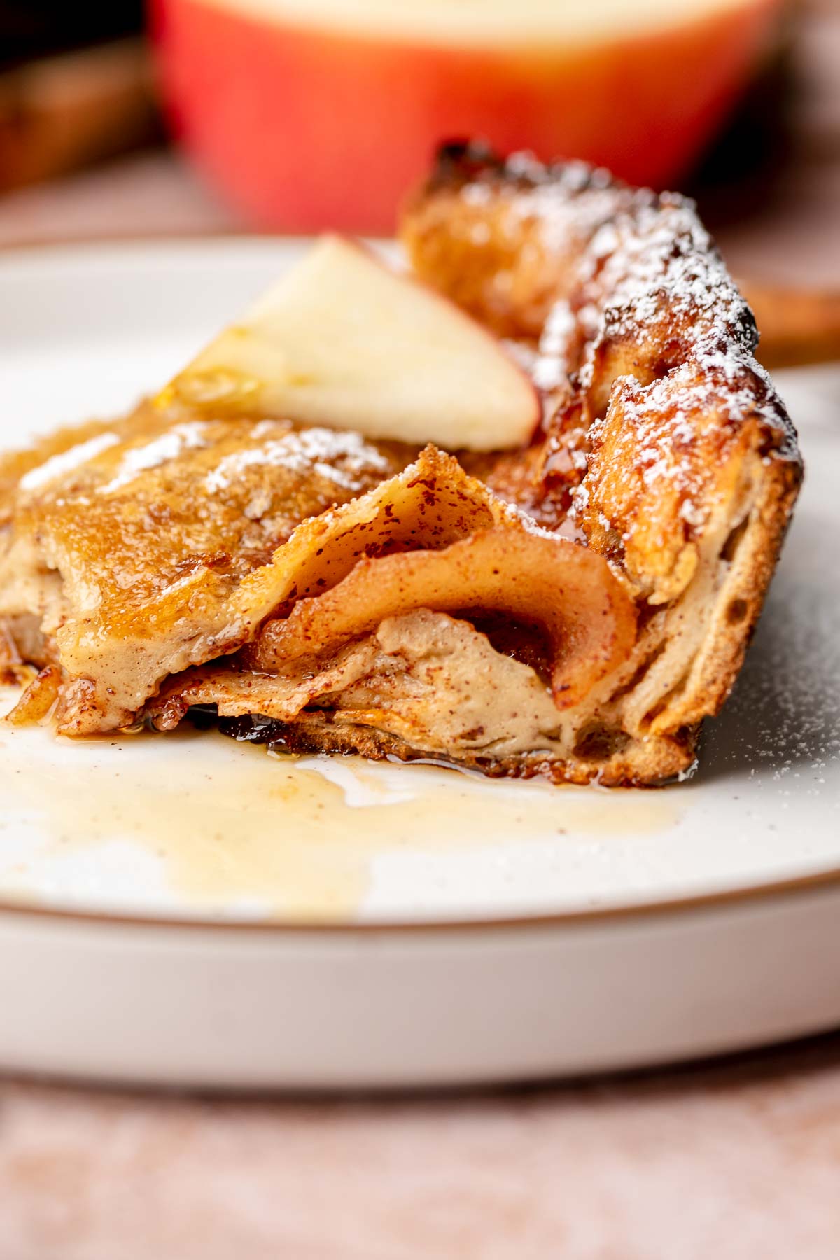 Cross section of a slice of cinnamon apple dutch baby.