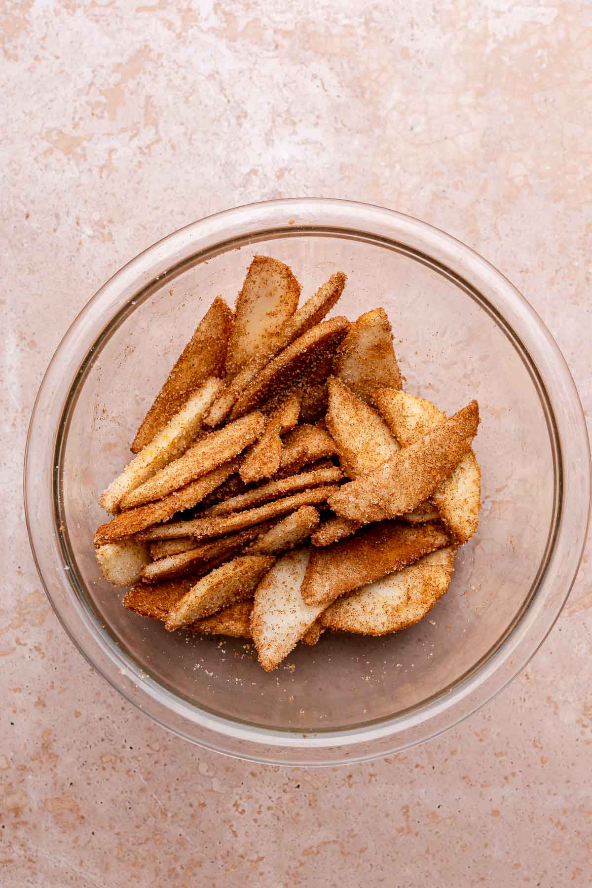 Sliced cinnamon sugar apples in a bowl.
