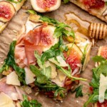 A slice of goat cheese and fig flatbread.