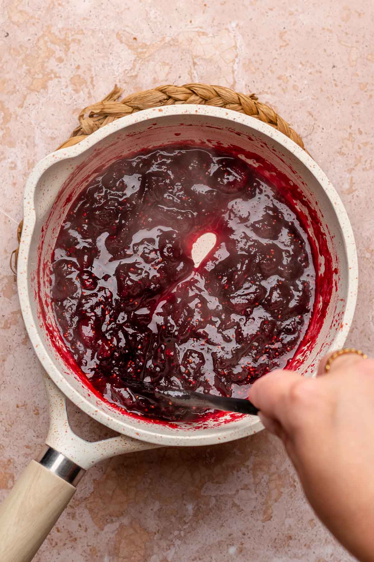 Cooked down cranberries in a pot.