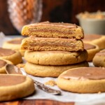Stacks of cinnamon brown sugar pop tart cookies. The two on top are split apart to show the filling.