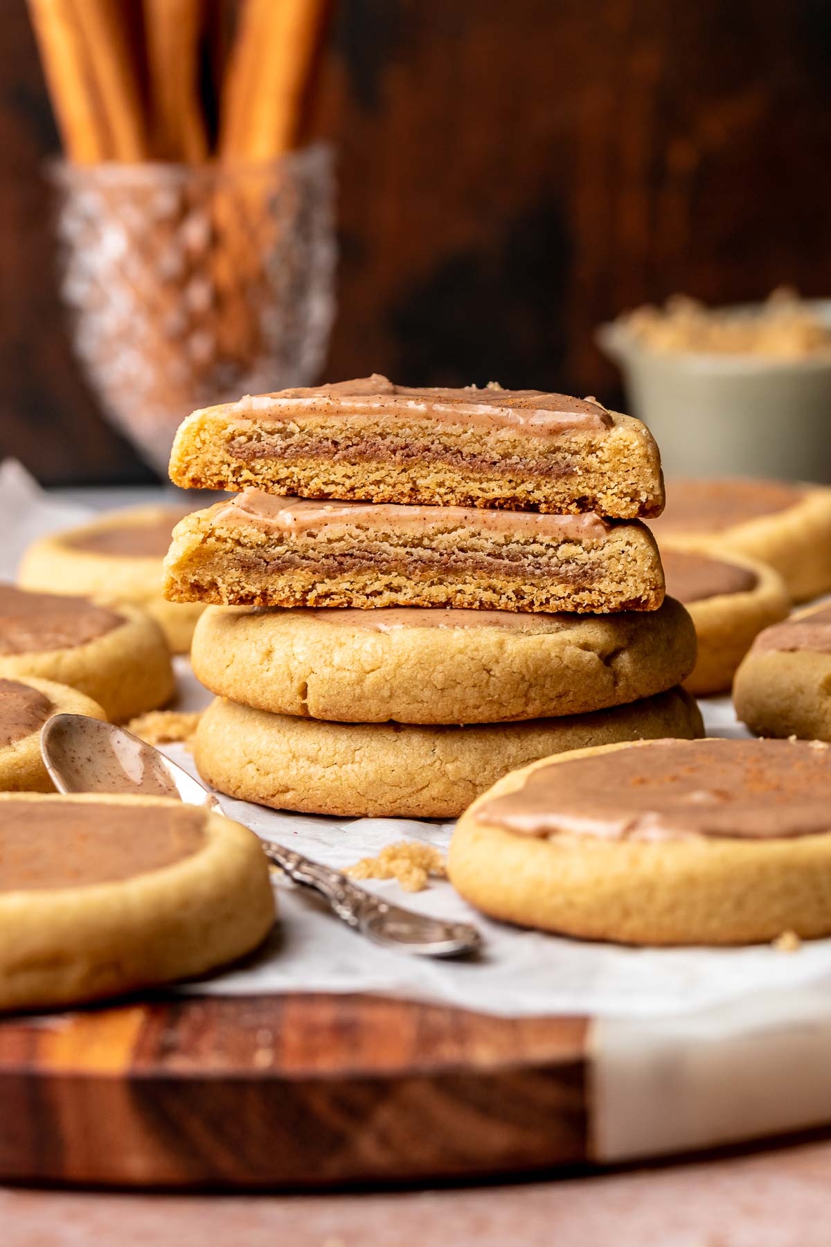 Stacks of cinnamon brown sugar pop tart cookies. The two on top are split apart to show the filling.
