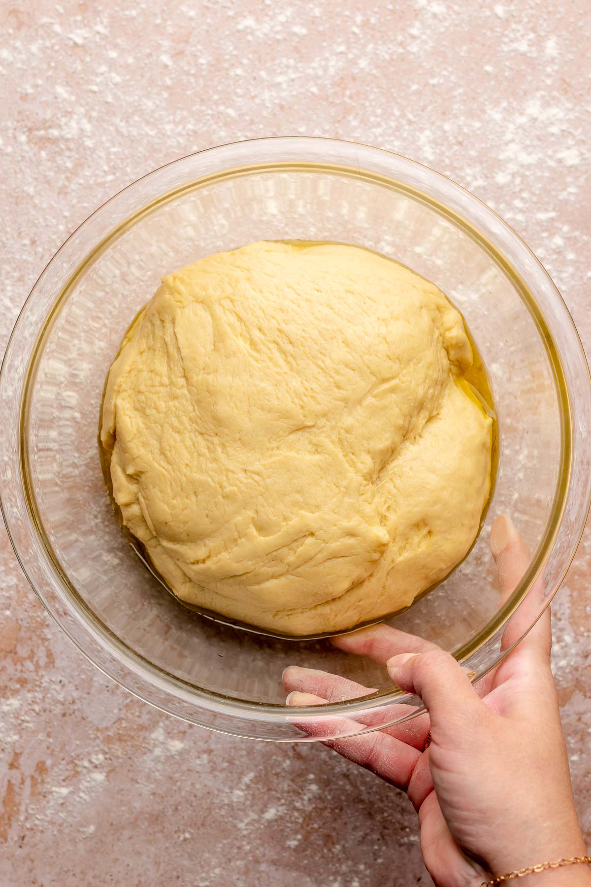 Risen ball of dough in a mixing bowl.