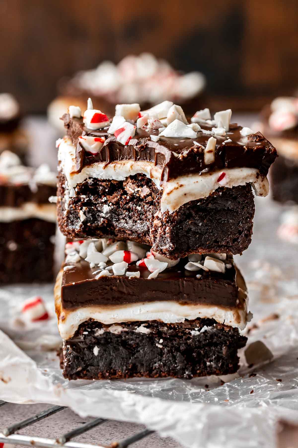 Two peppermint brownies stacked on top of each other. The top has a bite removed.