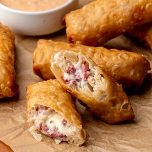 Reuben egg rolls cut in half to expose the center.