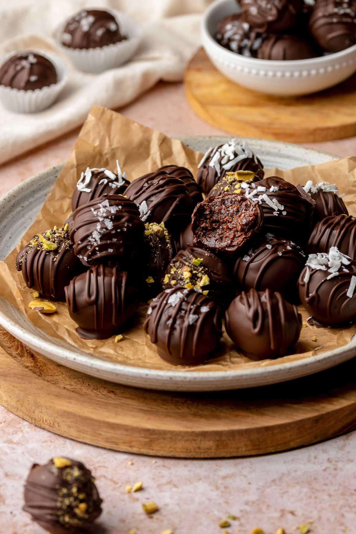 Brownie truffles on a plate. The top one has a bite removed.