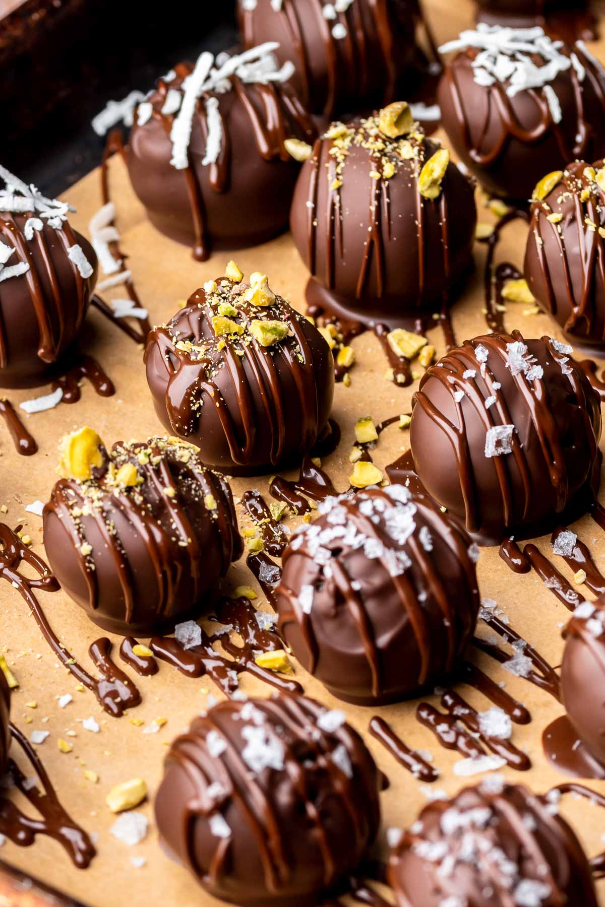 Decorated brownie truffles on parchment paper.