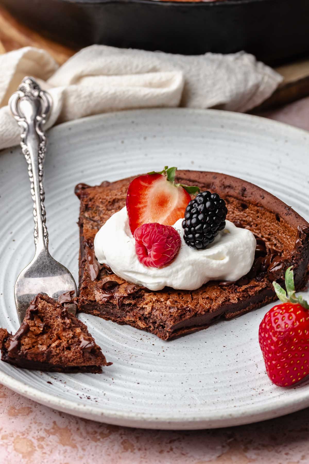 A slice of chocolate dutch baby on a palte with a fork.