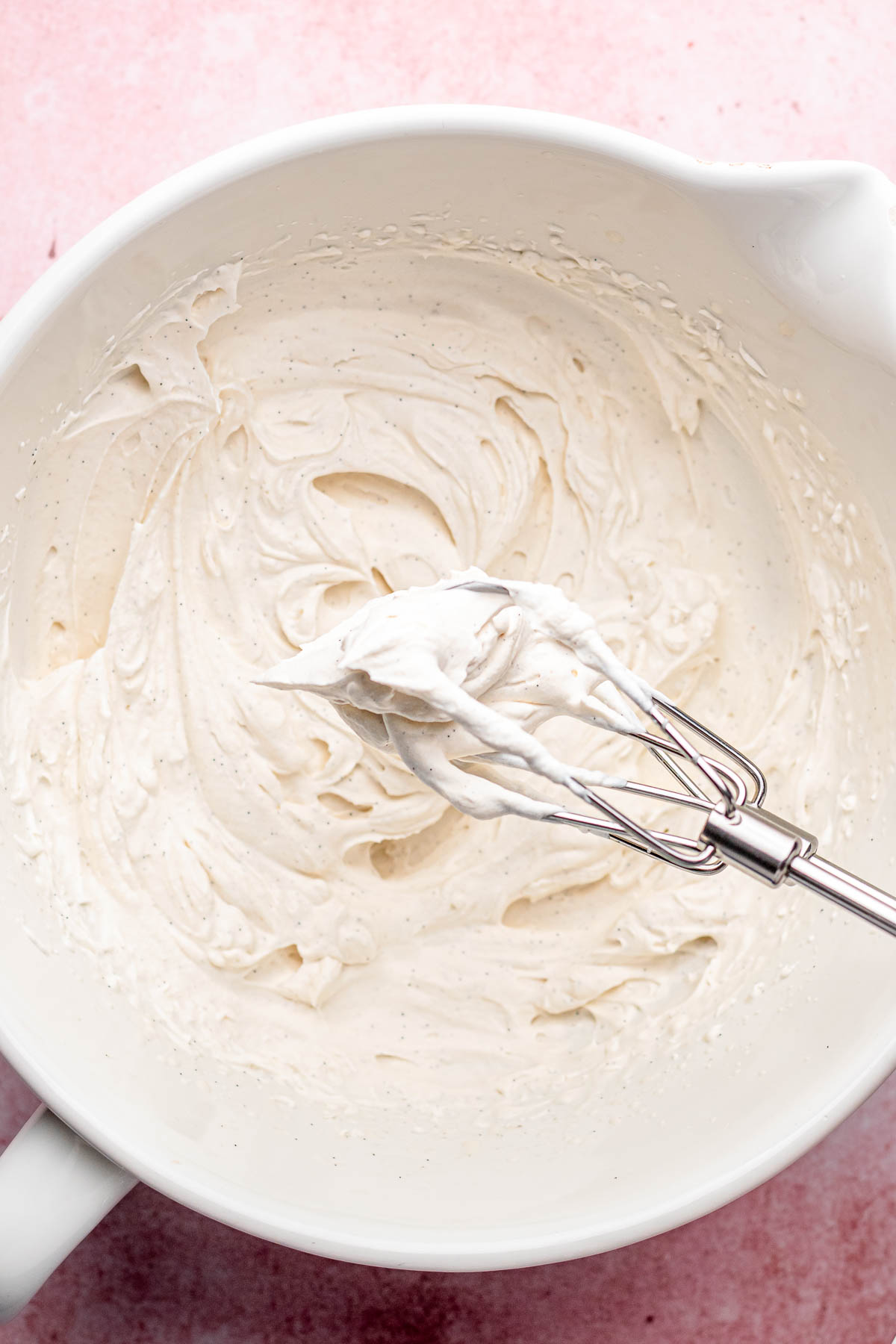 Whipped cream in a bowl and on beaters.