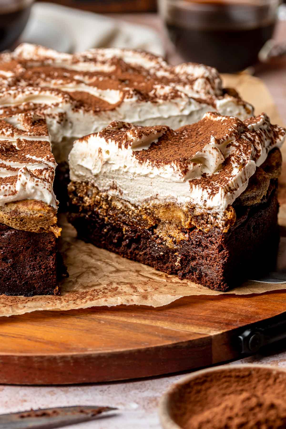 Sliced chocolate tiramisu cake on a platter.
