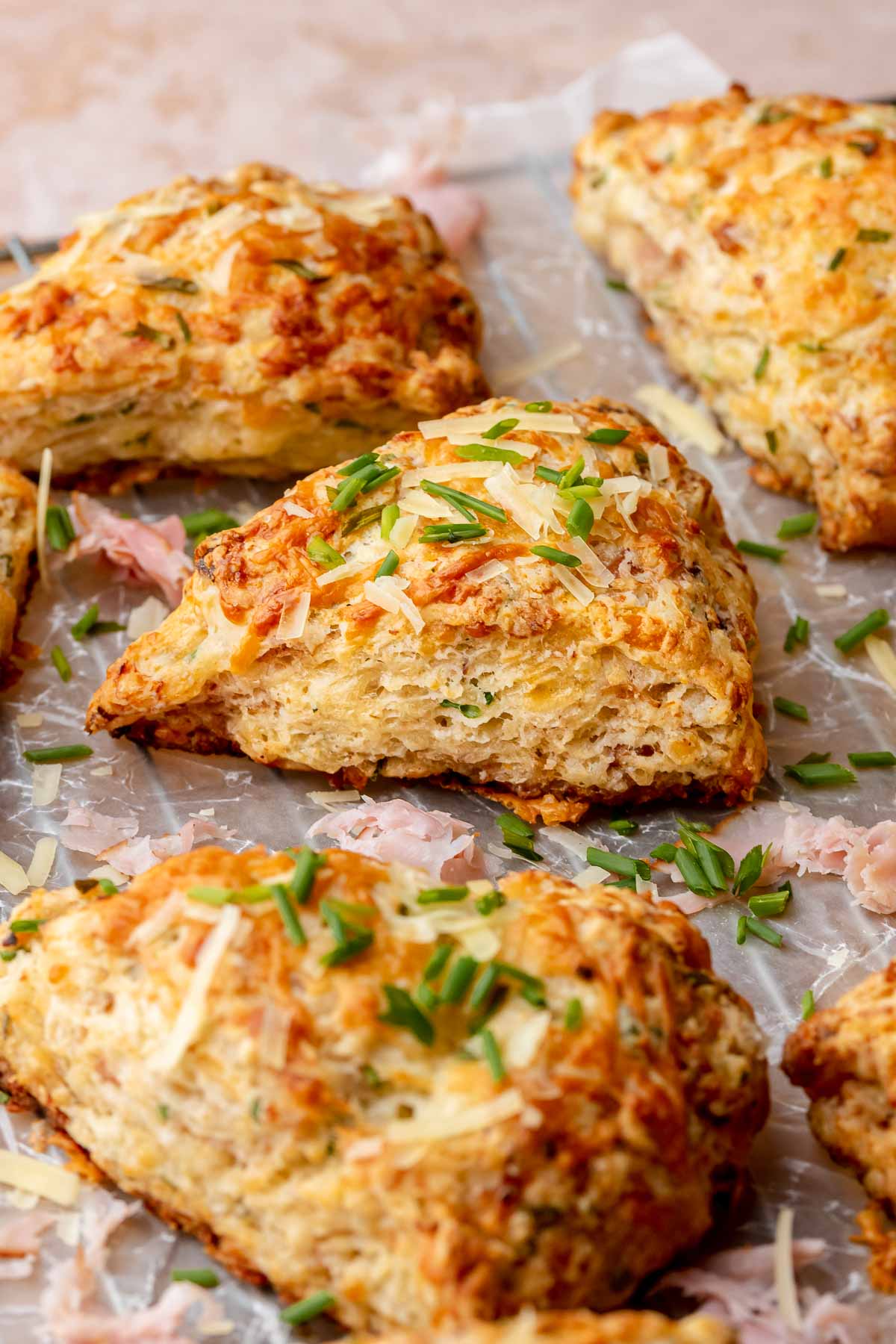 Baked ham and cheese scones on parhcment paper.