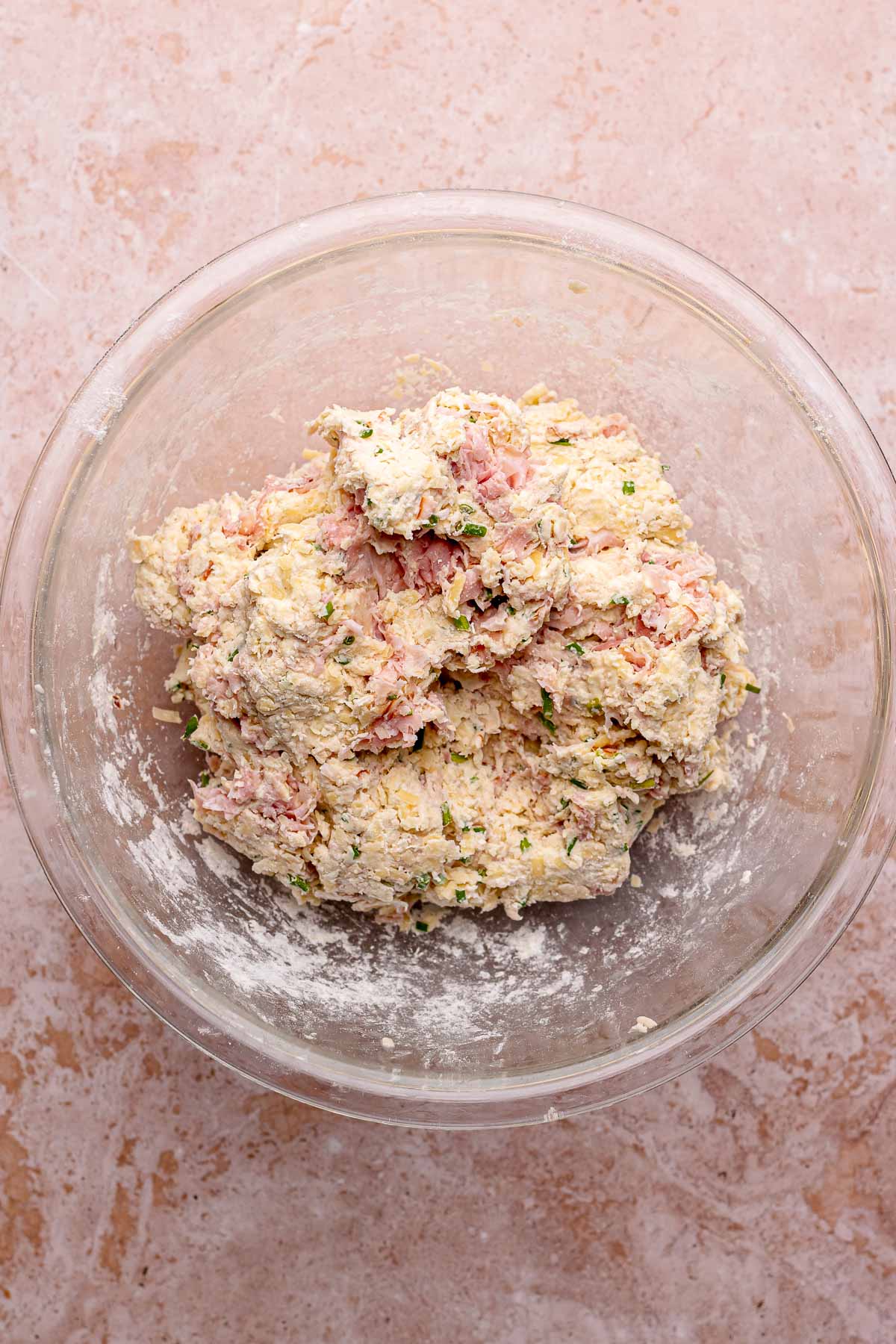 Finished ham and cheese scone dough mounded in a bowl.