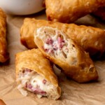 Reuben egg rolls cut in half to expose the center.