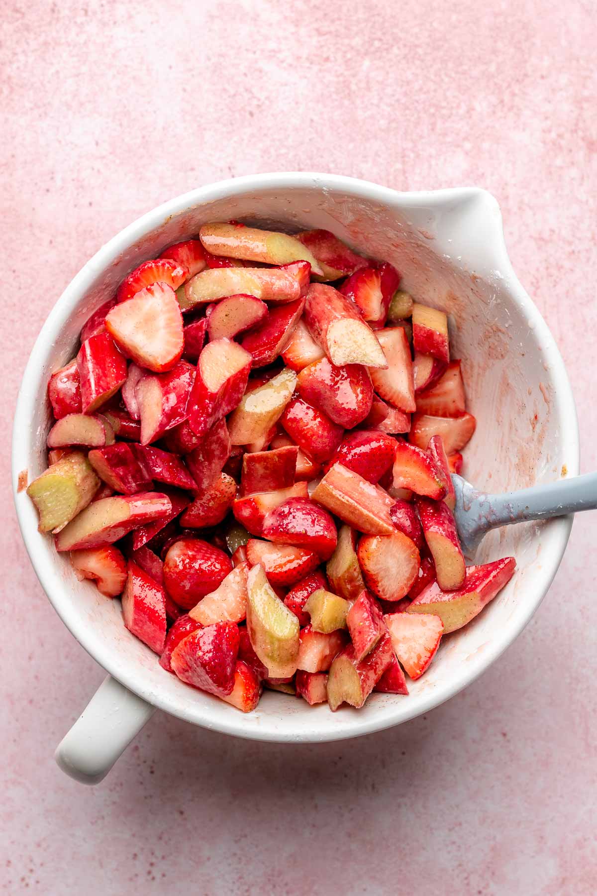 Strawberry and rhubarb pieces in a mixing bowl.