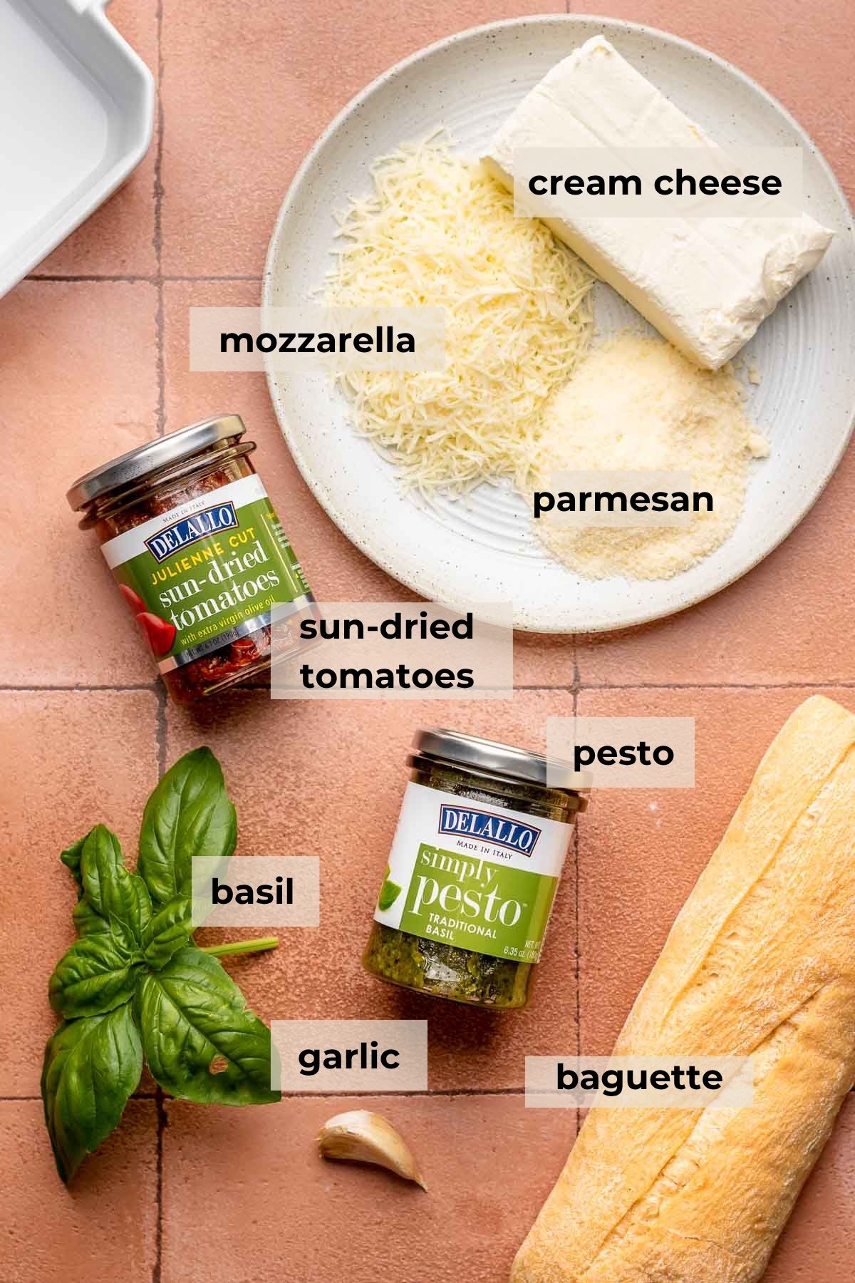 Ingredients for pesto and sun dried tomato dip.