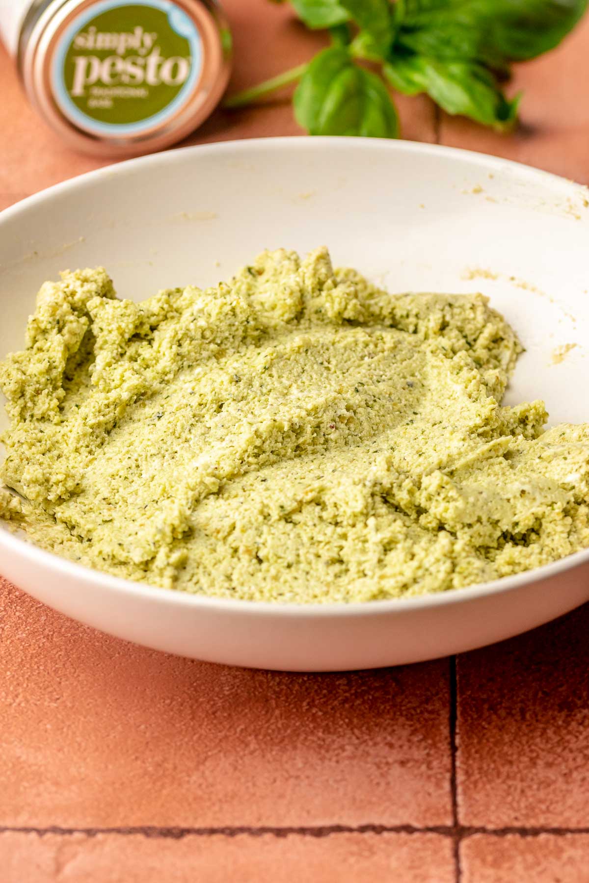 Pesto dip mixed in a bowl.
