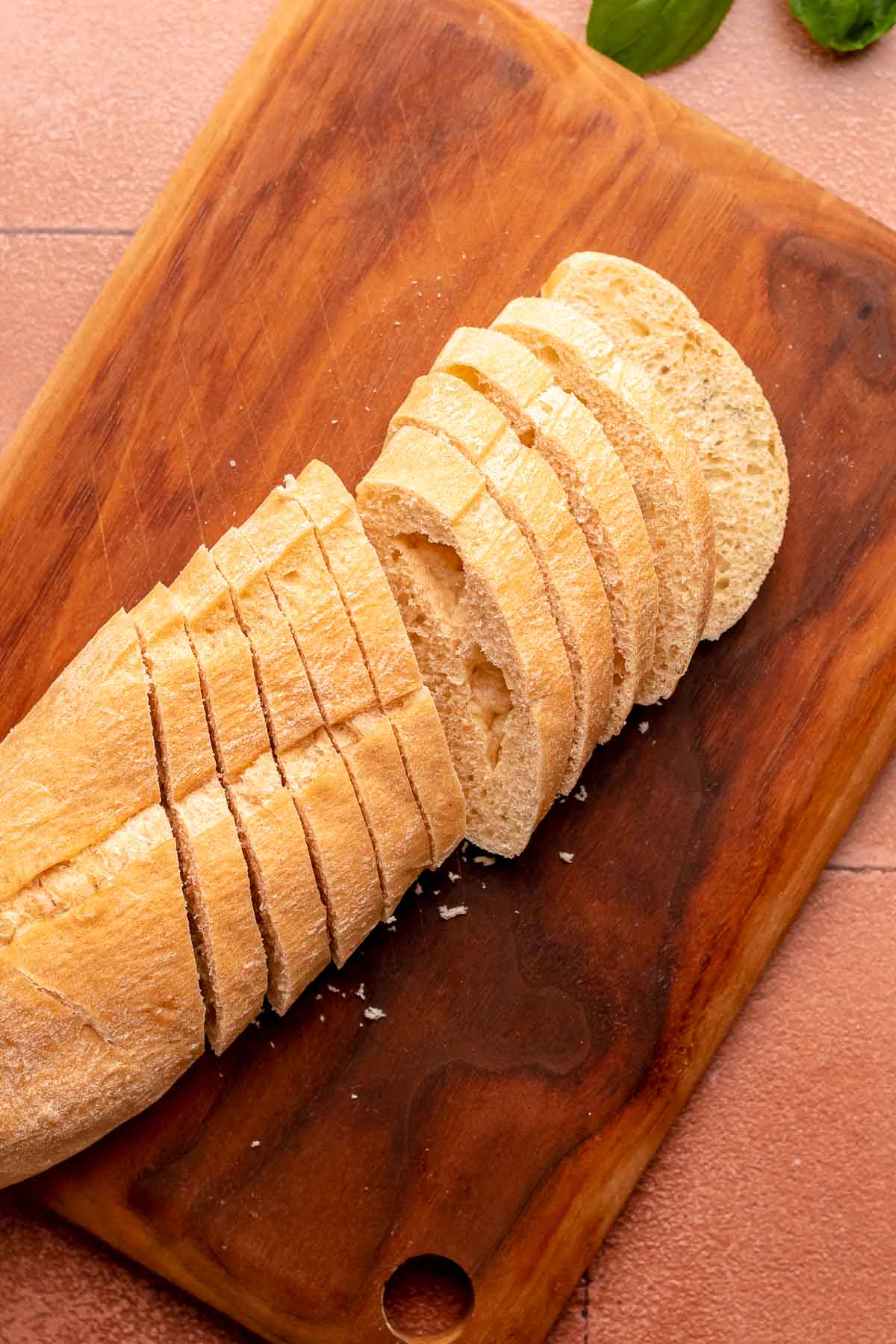 Sliced baguette on a cutting board.